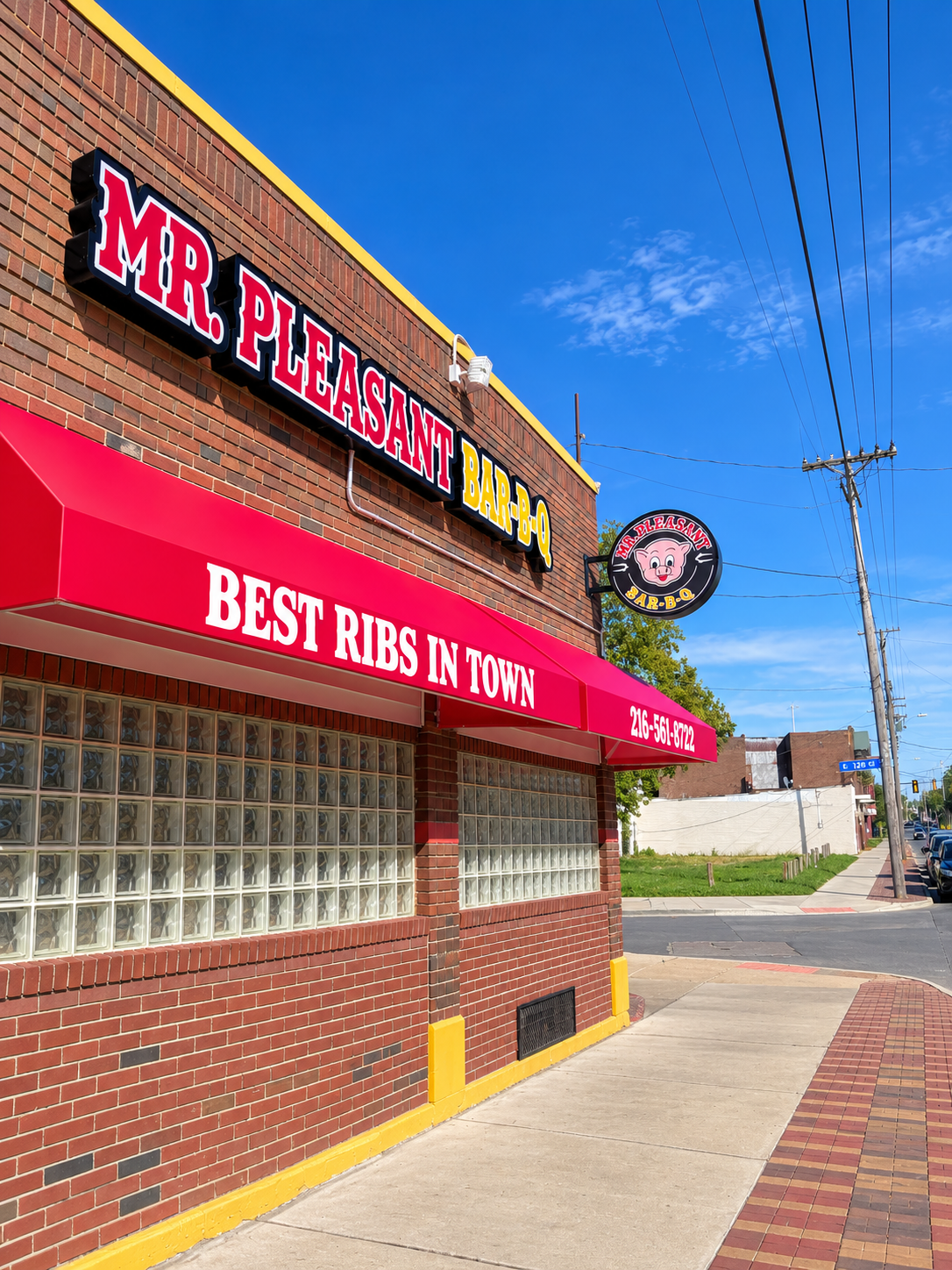 Red branded restaurant awning by Bnext Design